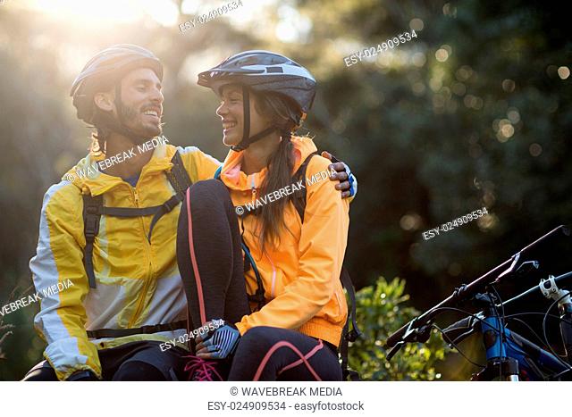 Biker couple sitting and interacting with each other