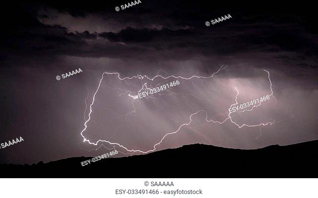 Closeup view of looping Lightning strike over mountain range