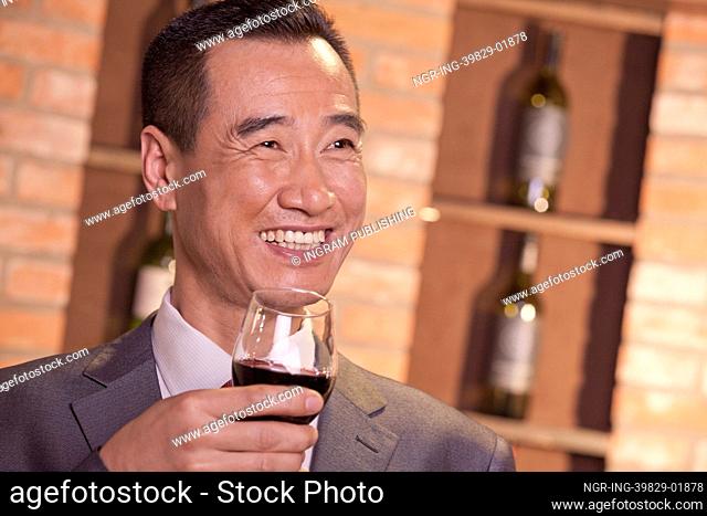 Smiling Businessman Holding Wine Glass