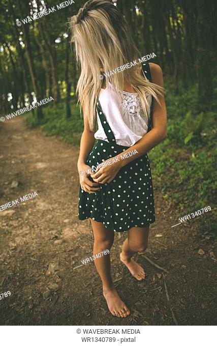 Gorgeous blonde standing on forest track