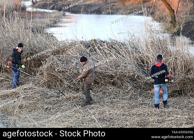 RUSSIA, KHERSON REGION - DECEMBER 20, 2023: People clean up a bank of the Kalanchak River. Alexei Konovalov/TASS