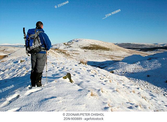 Hillwalker looking n/e across the Kilpatrick Hills to The Campsie Fells in Winter