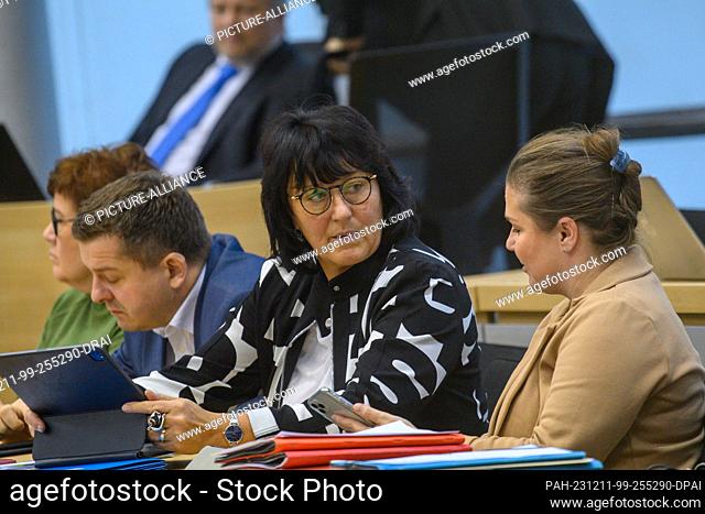 11 December 2023, Saxony-Anhalt, Magdeburg: Eva Feußner (M, CDU), Minister of Education of Saxony-Anhalt, sits at the government bench and speaks with Franziska...