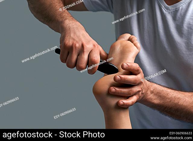 Foot reflexology massage. Beautiful woman receiving foot massage in spa salon