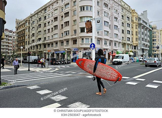 surfer crossing the street along Zurriola Beach, district of Gros, San Sebastian, Bay of Biscay, province of Gipuzkoa, Basque Country, Spain, Europe