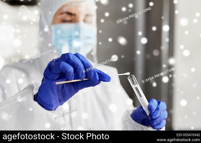 scientist holding beaker with coronavirus test