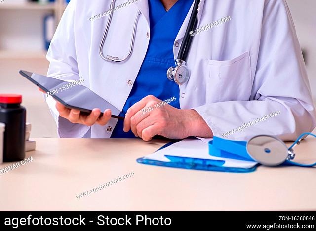 The old male doctor in telehealth concept