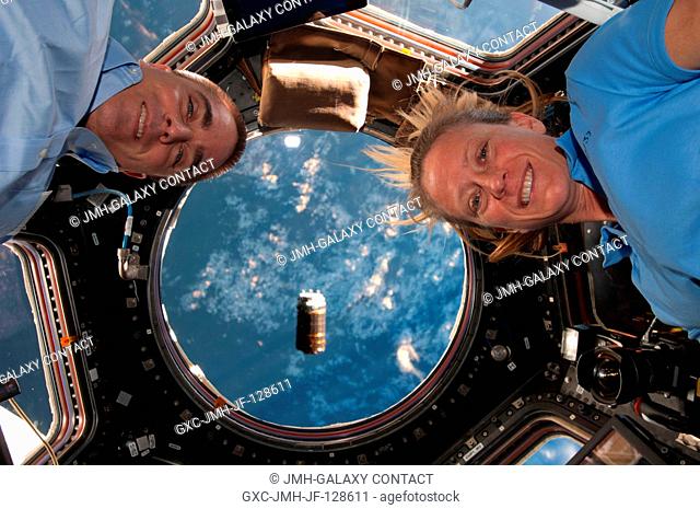 NASA astronauts Chris Cassidy and Karen Nyberg, both Expedition 36 flight engineers, are pictured near the windows in the International Space Station's Cupola...
