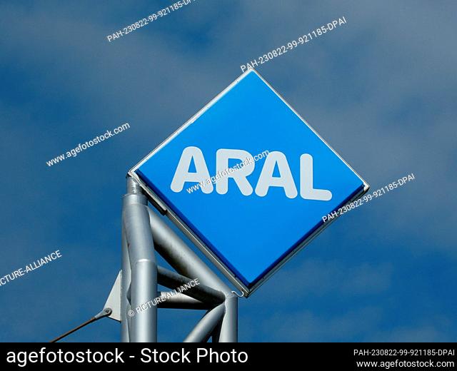 20 August 2023, North Rhine-Westphalia, Cologne: Logo, lettering of Aral AG on a gas station in front of blue sky a mineral oil company of BP group in Germany