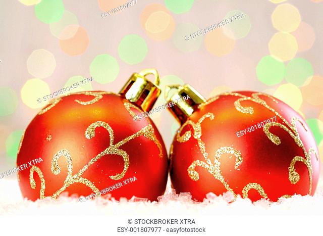 Red Christmas baubles with golden decor against glaring background