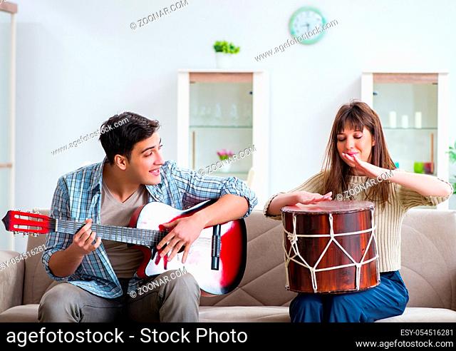 The young family singing and playing music at home
