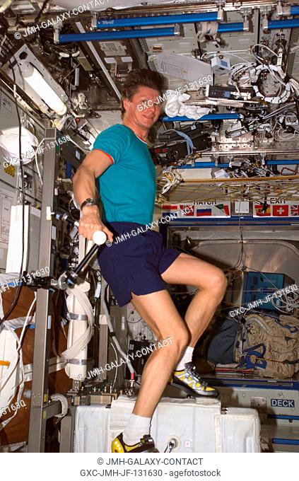 Cosmonaut Gennady I. Padalka, Expedition 9 commander representing Russia's Federal Space Agency, exercises on the Cycle Ergometer with Vibration Isolation...