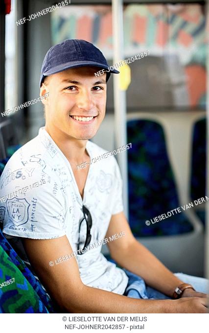 Teenage boy sitting in bus