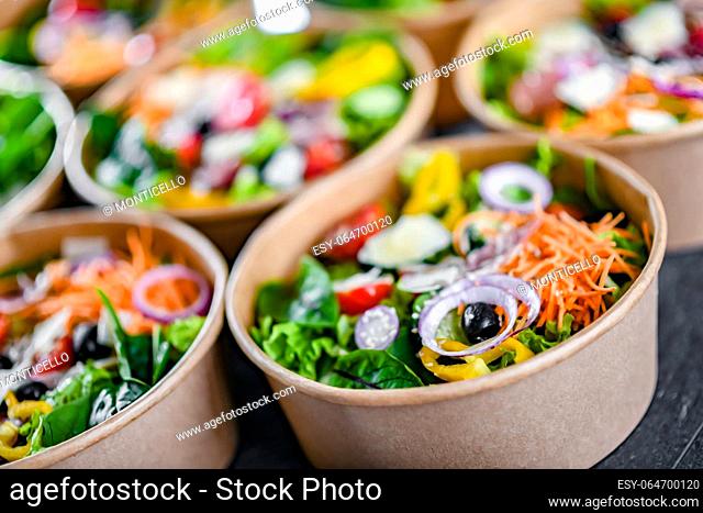 Round paper boxes with pre-packaged vegetable salads ready for sale