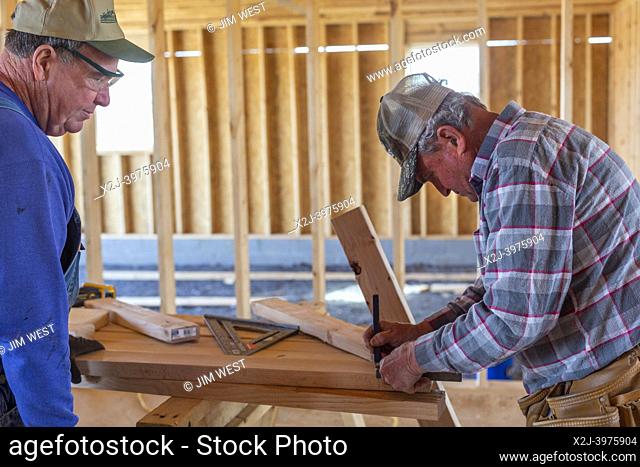 Mayfield, Kentucky - Volunteers from the United Methodist Church rebuild a home that was destroyed in the December 2021 tornado that devasted towns in western...