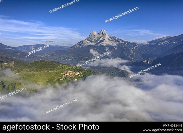 Aerial views of Pedraforca and the village of Maçaners over a sea of clouds in spring (BerguedÃ , Catalonia, Pyrenees, Spain)