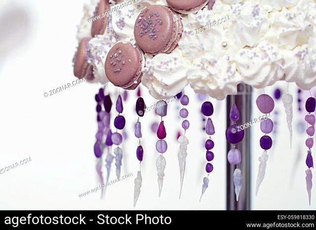 Detail macro shot of beautiful croquembouch macaron wedding cake on stand. Winter style