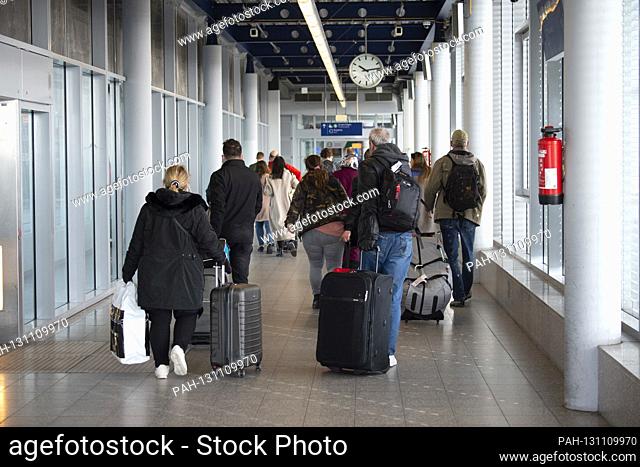 In the terminal at Duesseldorf Airport, travelers with luggage go in one aisle on Skytrain, Duesseldorf Airport, March 18, 2020