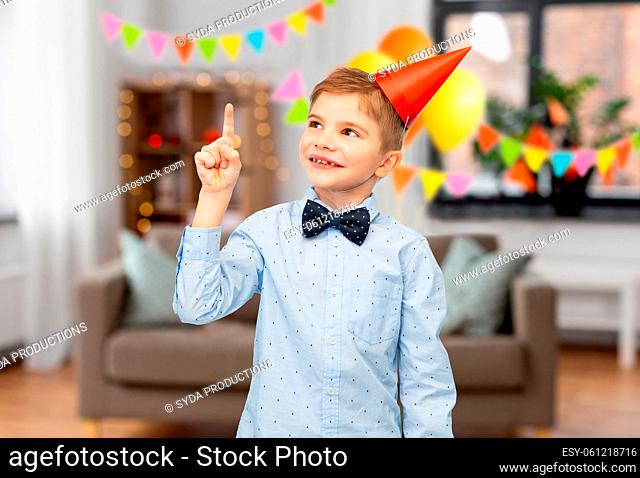 smiling little boy in birthday party hat