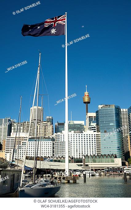 Sydney, New South Wales, Australia - A giant Australian flag is waving over Darling Harbour with Sydney's cityscape of the Central Business District and the...