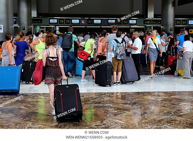 An airport in Tenerife experiences large queues for flights returning to the UK after the country's security level was raised Featuring: Atmosphere Where:...