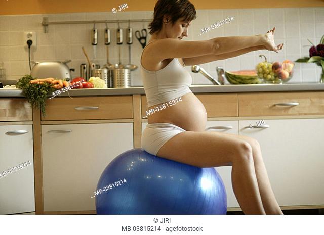 Kitchen, woman, pregnant, underwear,  Gymnastics ball, sitting, Dehnübung,  on the side,  Series, young, 20-30 years, short-haired, brunette, pregnant