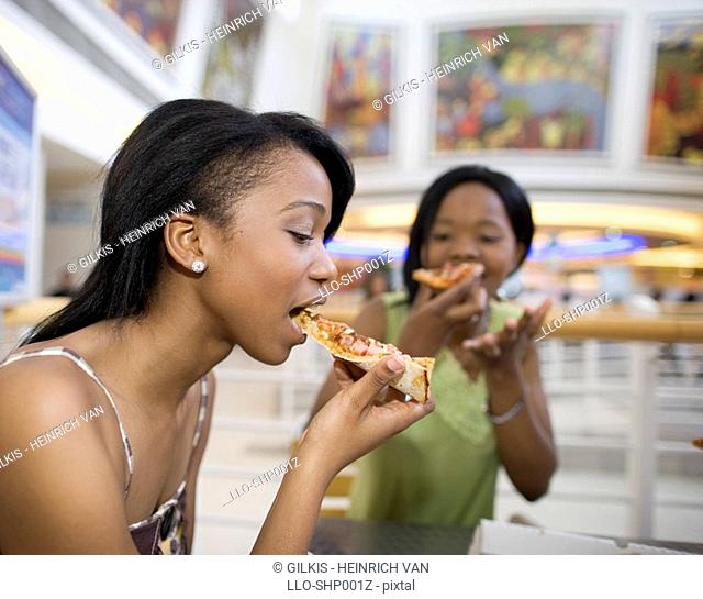 Friends eating pizza at mall, KwaZulu Natal Province, South Africa