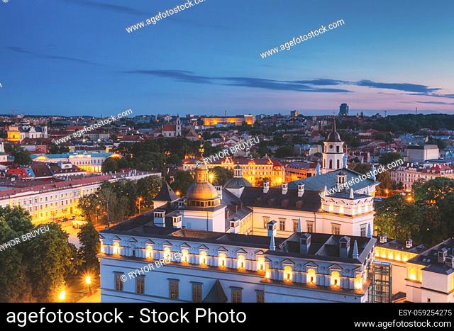 Vilnius, Lithuania, Eastern Europe. Aerial View Of Historic Center Cityscape In Blue Hour After Sunset. Travel View Of Old Town In Night Illuminations