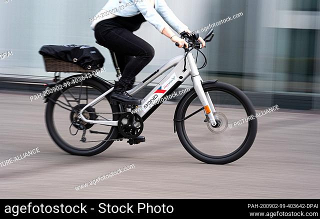 02 September 2020, Hamburg: A woman rides an e-bike from Bond Mobility during a press meeting of Free Now and Bond Mobility