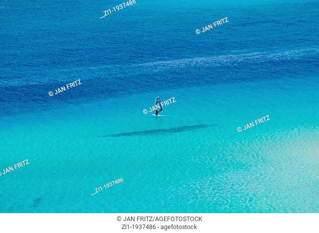blue sea with windsurfer at Spiaggia, Sardinia