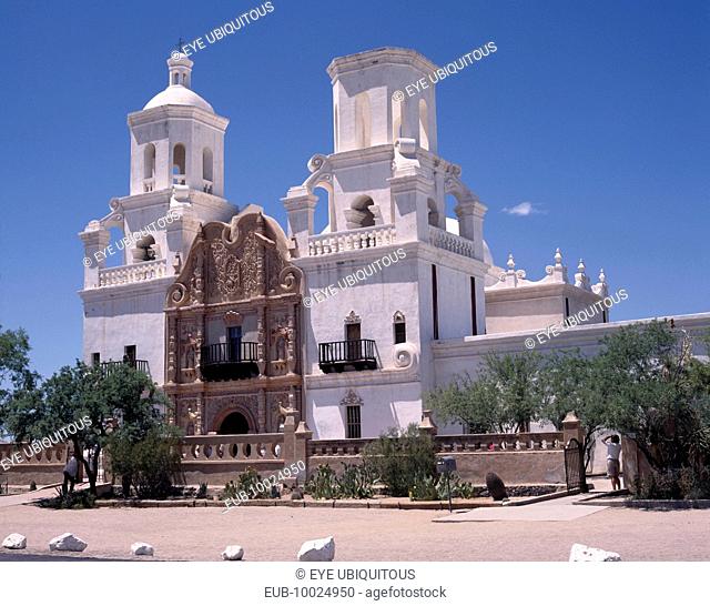 San Xavier del Bac Mission. White-washed building with towers an ornate entrance and balconies