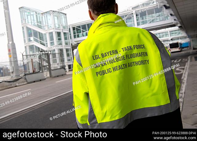 24 January 2020, Bavaria, Munich: ""Task Force - Infectiology Airport"" is written on the jacket of an employee of the ""Task Force Infectiology"" at Munich...