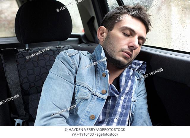 Young Man Sleeping in Car