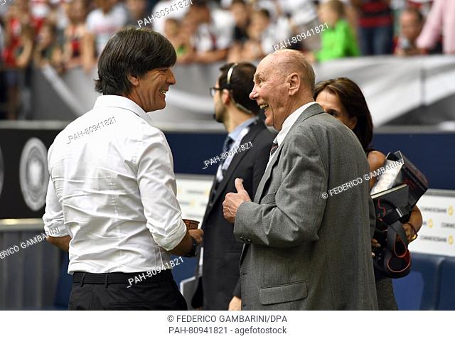 Germany's head coach Joachim Loew (L) talks to German former soccer player Horst Eckel prior to the international soccer friendly match between Germany and...