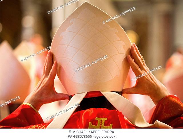 A cardinal puts on his mitre during the religious mass 'Pro Eligendo Romano Pontifice' at Saint Peter's Basilica in the Vatican, Vatican City, 12 March 2013