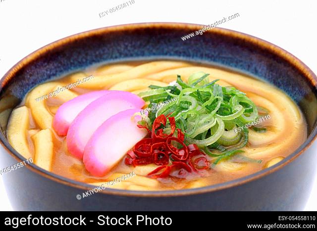 Close up of Japanese curry udon noodles in a bowl on white background