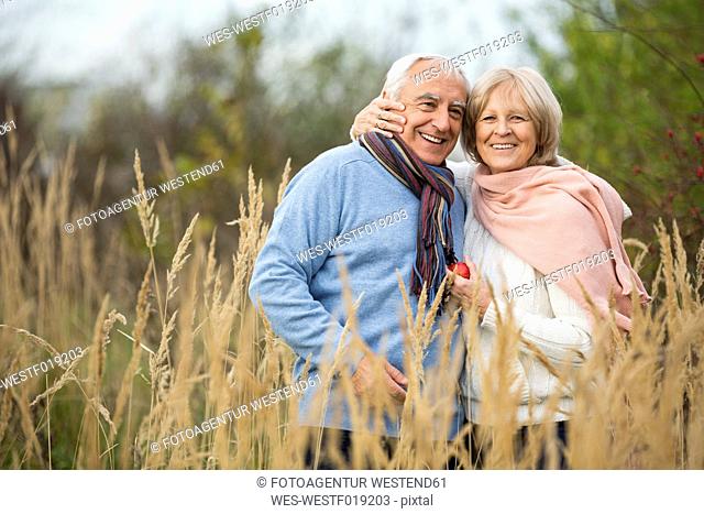 Portrait of happy senior couple having a walk