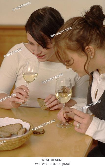 Two women testing wine