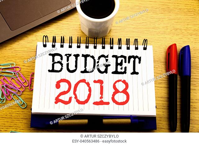 Hand writing text caption showing Budget 2018. Business concept for Household budgeting accounting planning written on notebook on the wooden background in the...