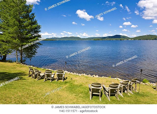 Adirondack chairs on lawn on Fourth Lake in the Adirondack Mounatins of New York State