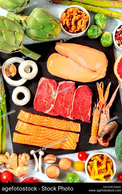 Proteins. Meat, fish, chicken, seafood, shot from above with nuts, mushrooms, and vegetables, the concept of a nutritious meal