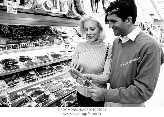 Couple reading meat label