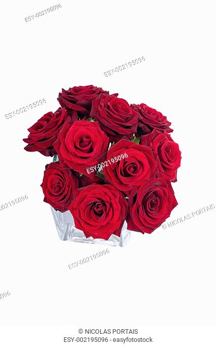 Bunch of red rose flowers in a small vase top view