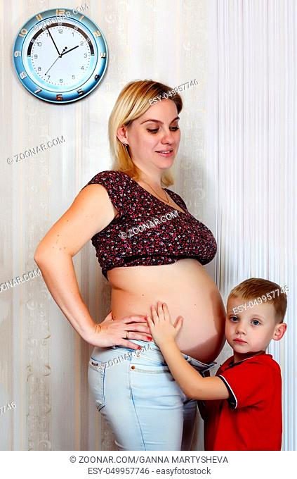 Young pregnant mother with her little son. A happy family. Conception: Happy motherhood, Mother's Day