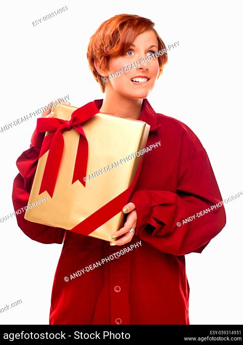 Pretty Red Haired Girl Biting Her Lip Holding Wrapped Gift Isolated on a White Background