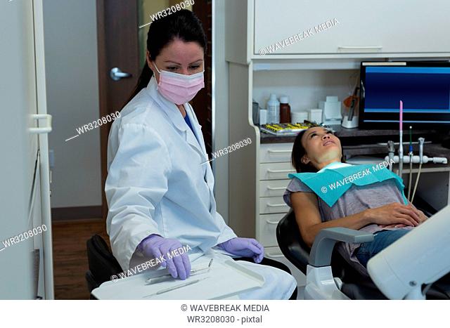 Female dentist examining a patient