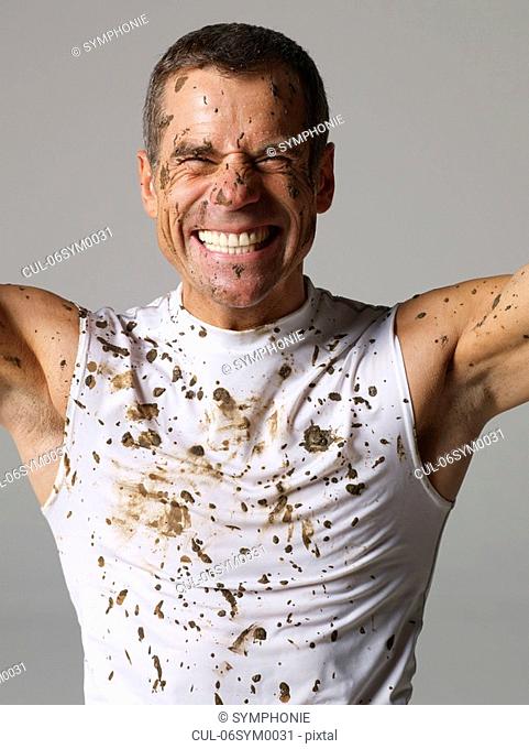 Joyous mud covered man