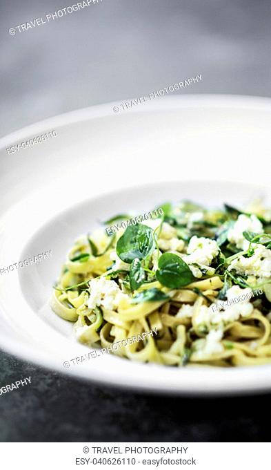gourmet organic italian ricotta and fresh mixed herbs tagliatelle on plate