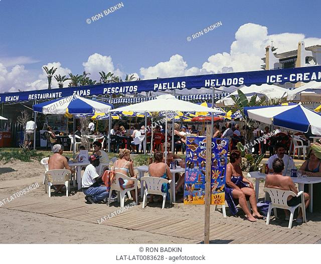 Puerto Cabopino. ndy's beachbar. Awnings/ tables/ chairs. People seated