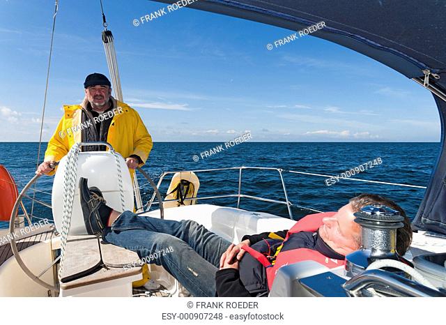 Two men on board a sailing yacht